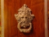 trompe door knocker with wood grained background